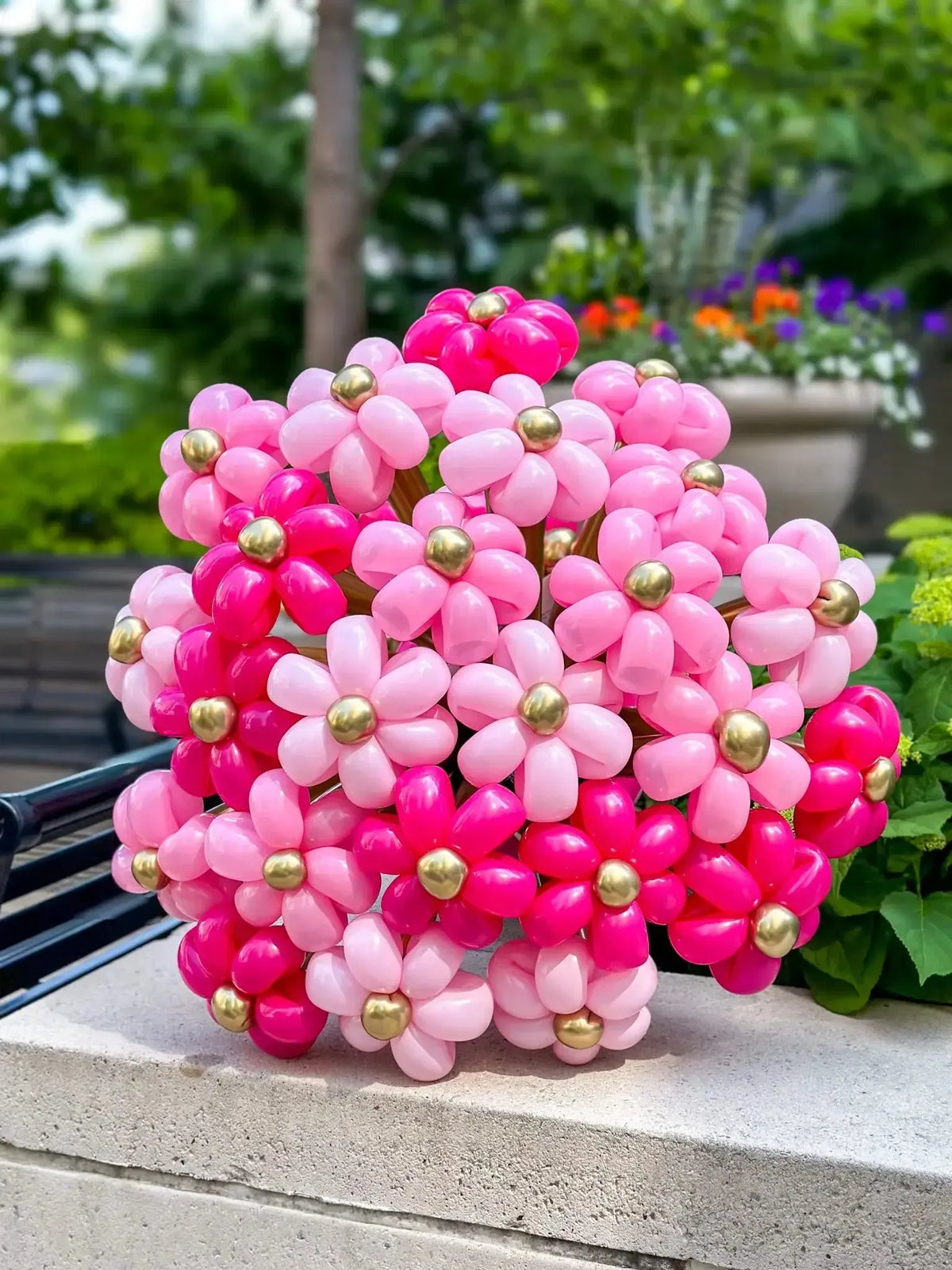 Vibrant pink and gold balloon flower bouquet, perfect for unique gifts and festive celebrations.
